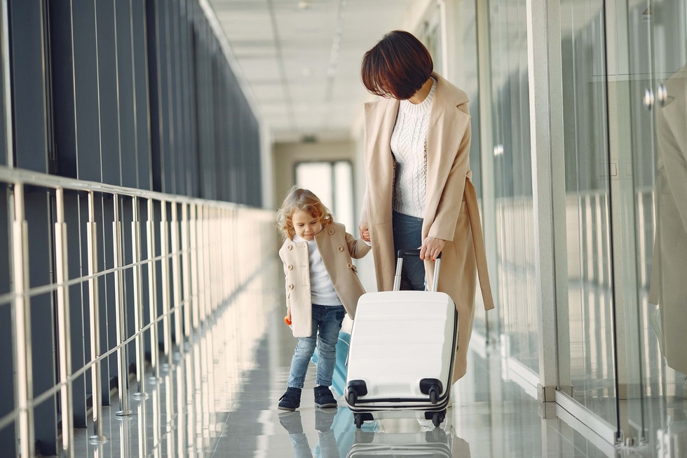 mother and daughter travelling at an airport