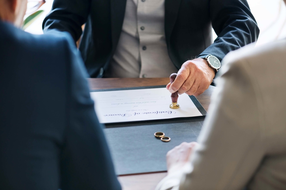 A couple signing the divorce papers
