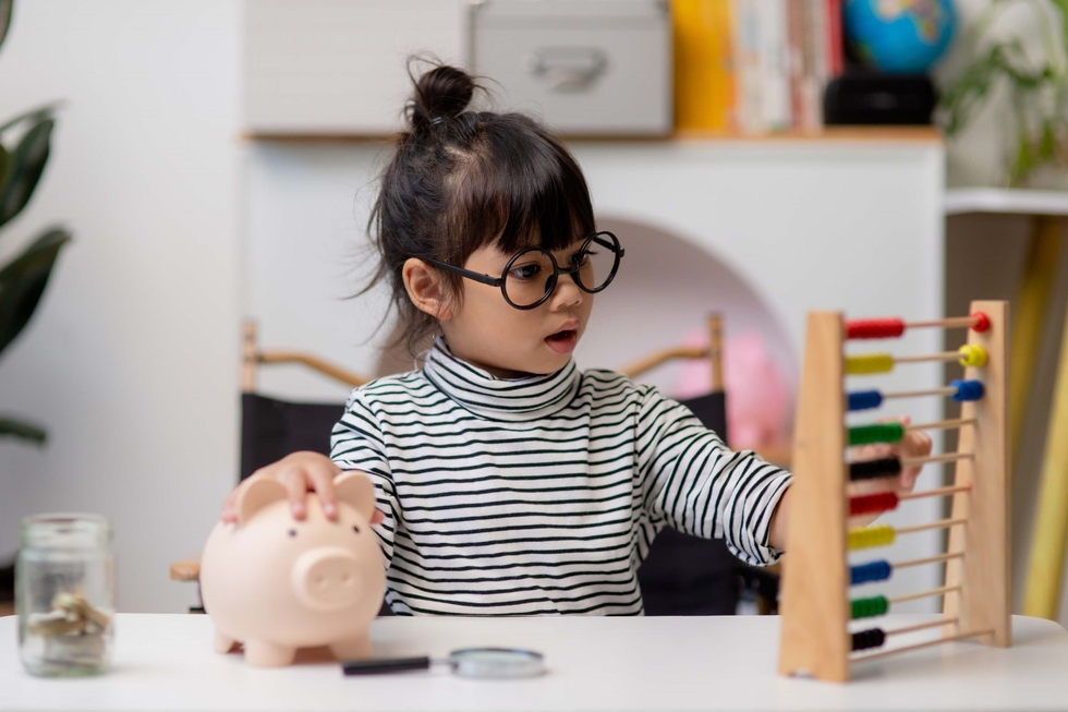 A photo of a small child counting money